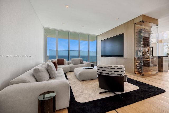 living area with expansive windows and wood finished floors