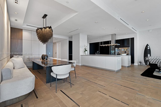 dining space featuring a raised ceiling
