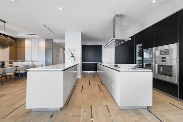 kitchen with light countertops, dark cabinetry, modern cabinets, and island range hood