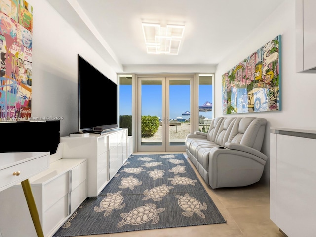 living area with tile patterned floors and french doors