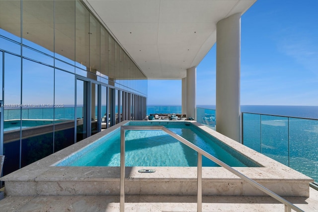 view of swimming pool featuring a water view