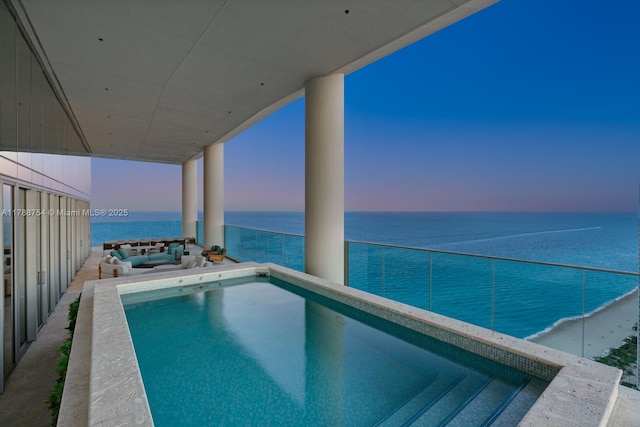 pool at dusk with a water view