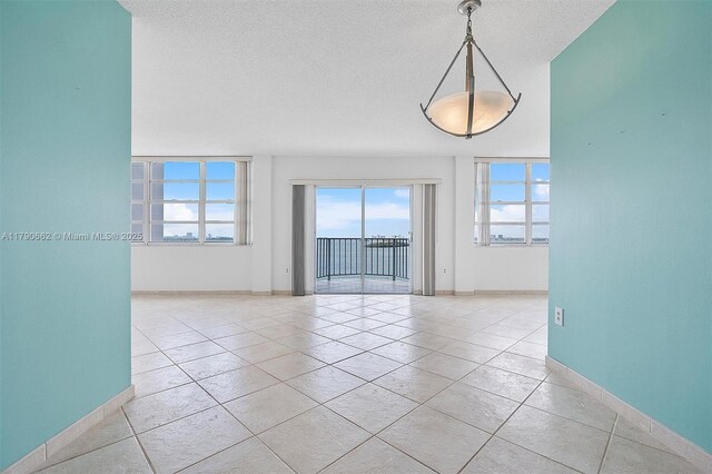 11930 N Bayshore Dr Unit 1007, North Miami, FL 33181 - empty room with light tile patterned floors, baseboards, and plenty of natural light