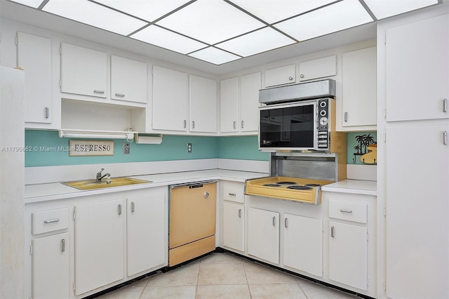 11930 N Bayshore Dr Unit 1007, North Miami, FL 33181 - kitchen with stainless steel microwave, light tile patterned floors, light countertops, dishwasher, and a sink