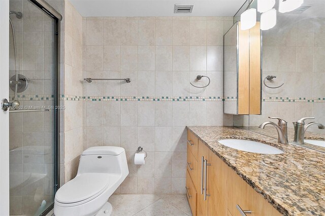 11930 N Bayshore Dr Unit 1007, North Miami, FL 33181 - full bath featuring toilet, visible vents, a shower stall, and tile walls