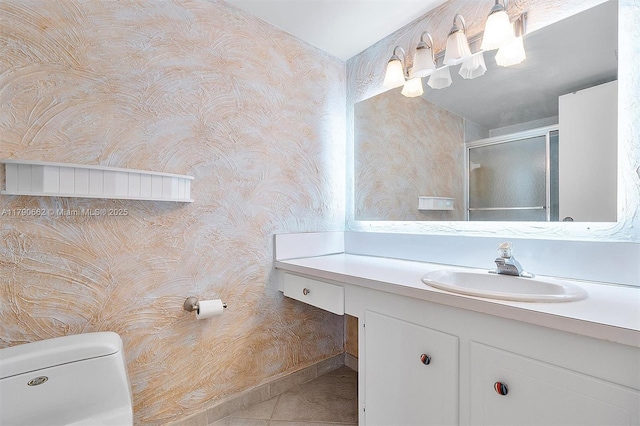 11930 N Bayshore Dr Unit 1007, North Miami, FL 33181 - bathroom with wallpapered walls, a stall shower, toilet, vanity, and tile patterned flooring