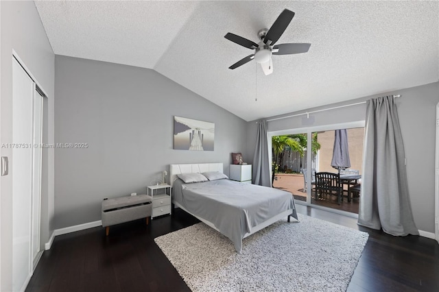 bedroom featuring a textured ceiling, access to exterior, baseboards, and lofted ceiling
