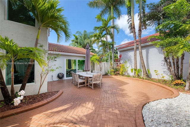 view of patio with outdoor dining area and fence
