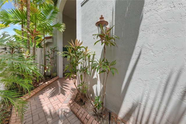 exterior details featuring arched walkways and stucco siding