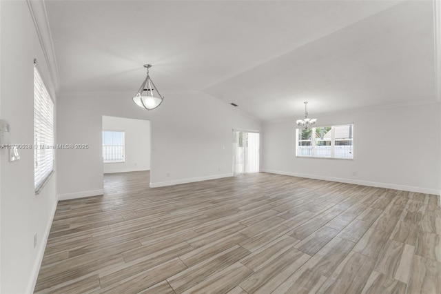 interior space featuring crown molding, light wood-type flooring, a chandelier, and baseboards