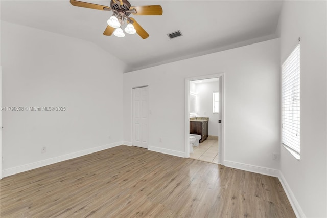 unfurnished bedroom with multiple windows, light wood-style flooring, and visible vents