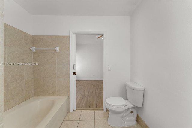 full bath with toilet, tile patterned flooring, and baseboards