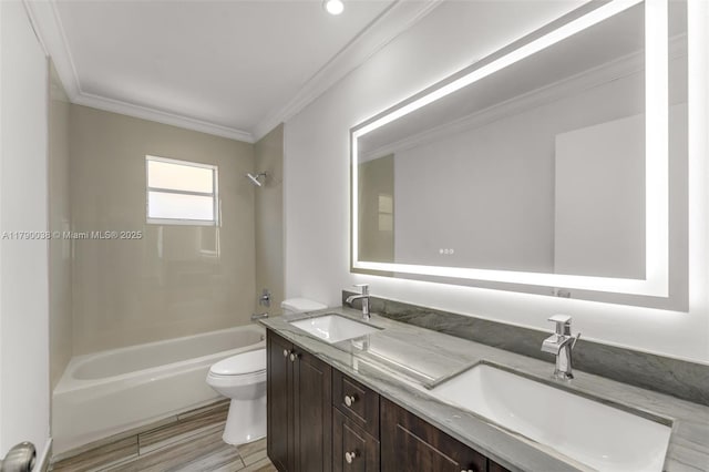 bathroom with toilet, ornamental molding, tub / shower combination, and a sink