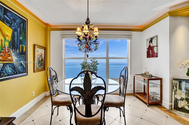 3500 Galt Ocean Dr Unit 1007, Fort Lauderdale, FL 33308 - dining area with crown molding, light tile patterned flooring, a textured ceiling, a water view, and a notable chandelier