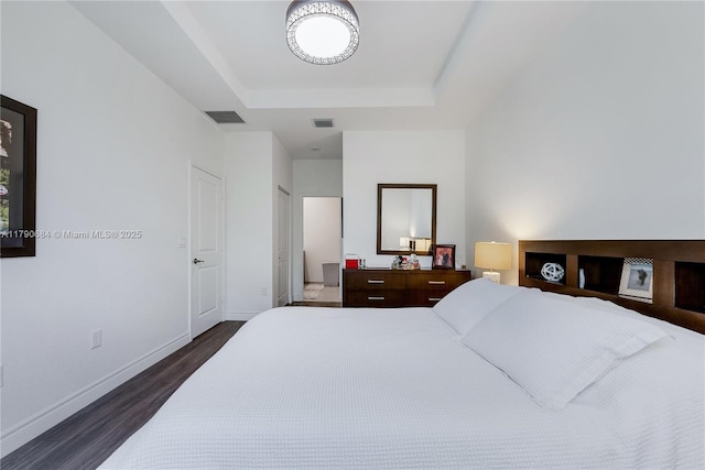21364 NE 2nd Ct, Miami, FL 33179 - bedroom with dark wood-style flooring, visible vents, a tray ceiling, and baseboards