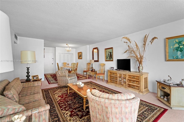 5601 Collins Ave Unit 1014, Miami Beach, FL 33140 - carpeted living area featuring a textured ceiling, a notable chandelier, and visible vents