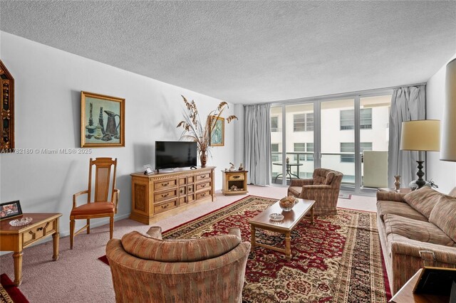 5601 Collins Ave Unit 1014, Miami Beach, FL 33140 - living room featuring a textured ceiling, floor to ceiling windows, and carpet