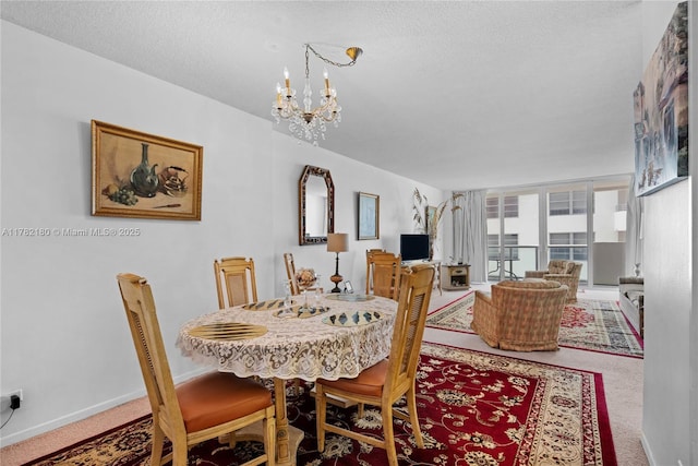 5601 Collins Ave Unit 1014, Miami Beach, FL 33140 - carpeted dining space featuring baseboards, a textured ceiling, and a chandelier