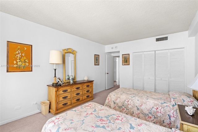 5601 Collins Ave Unit 1014, Miami Beach, FL 33140 - bedroom with a textured ceiling, visible vents, baseboards, a closet, and carpet