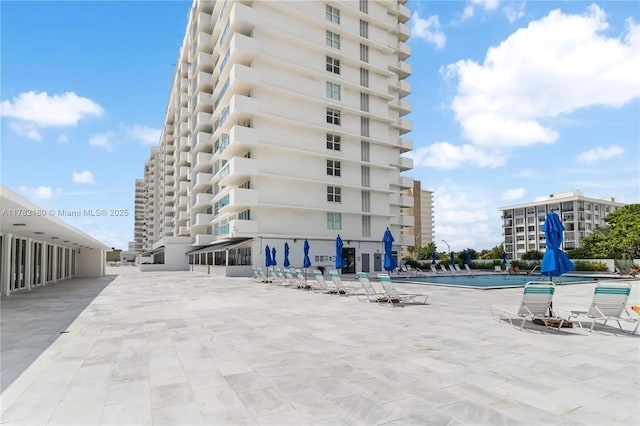 5601 Collins Ave Unit 1014, Miami Beach, FL 33140 - view of building exterior with a community pool