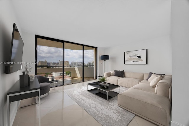 living area featuring tile patterned floors and a wall of windows