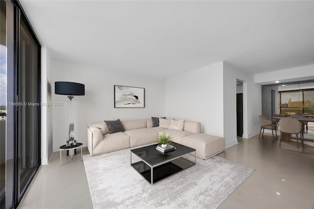 living room featuring baseboards and light tile patterned flooring