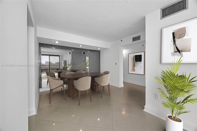 dining room with baseboards, visible vents, and light tile patterned flooring
