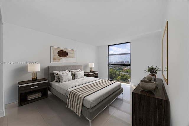 bedroom with light tile patterned flooring and baseboards