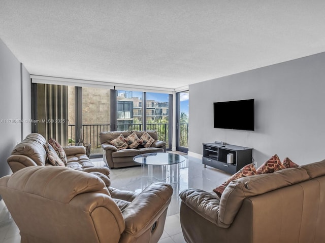 2101 S Ocean Dr Unit 401, Hollywood, FL 33019 - tiled living room with a textured ceiling, expansive windows, and baseboards