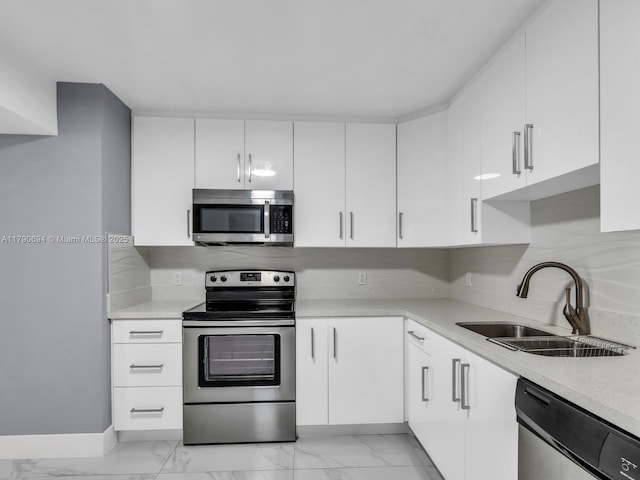 2101 S Ocean Dr Unit 401, Hollywood, FL 33019 - kitchen featuring white cabinets, stainless steel appliances, marble finish floor, and a sink