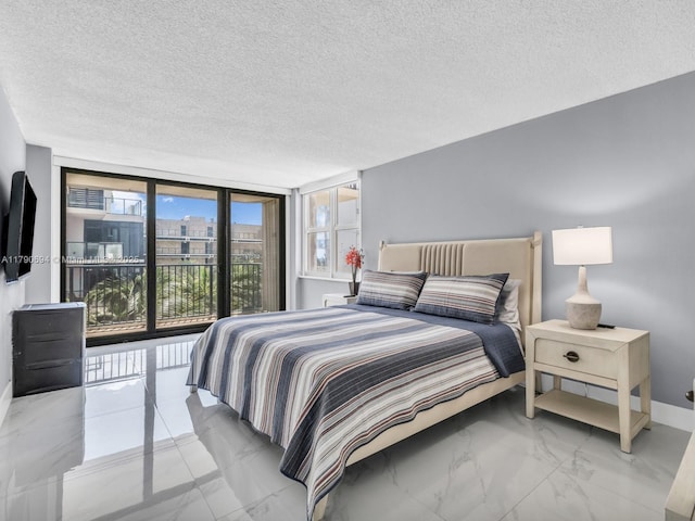 2101 S Ocean Dr Unit 401, Hollywood, FL 33019 - bedroom with a textured ceiling, access to exterior, baseboards, a wall of windows, and marble finish floor