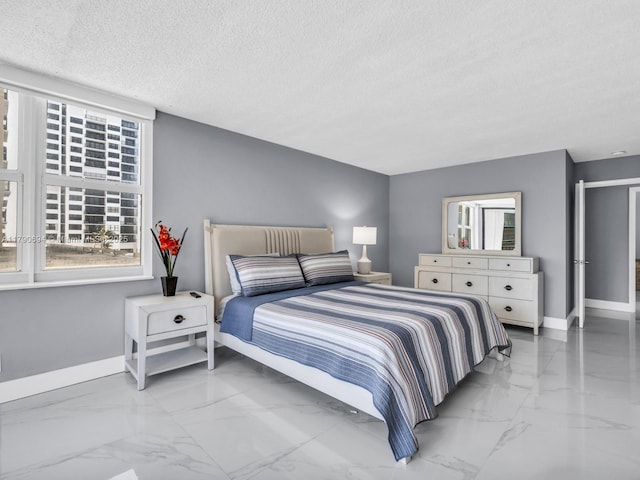 2101 S Ocean Dr Unit 401, Hollywood, FL 33019 - bedroom with baseboards, a textured ceiling, and marble finish floor