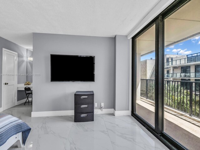 2101 S Ocean Dr Unit 401, Hollywood, FL 33019 - bedroom with a textured ceiling, access to exterior, marble finish floor, and baseboards