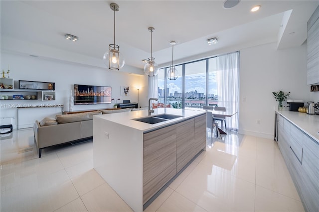 kitchen with a sink, light tile patterned flooring, modern cabinets, and light countertops