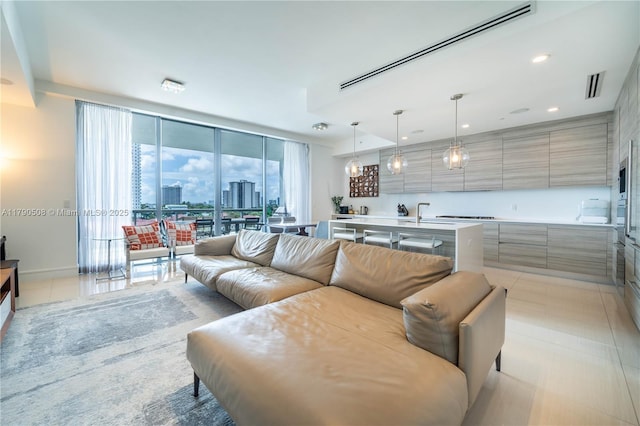 living area with a view of city, visible vents, baseboards, and recessed lighting