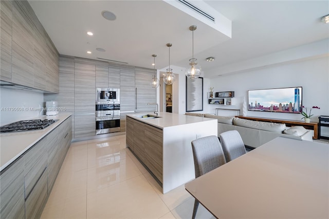 kitchen featuring light tile patterned floors, stainless steel appliances, and modern cabinets