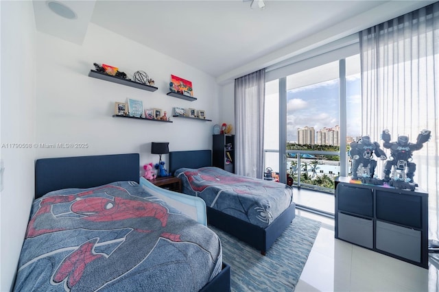 bedroom with access to outside and a city view