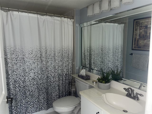 bathroom with toilet, vanity, and a shower with shower curtain