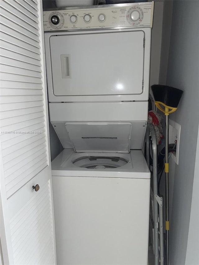 laundry area featuring stacked washer and dryer and laundry area
