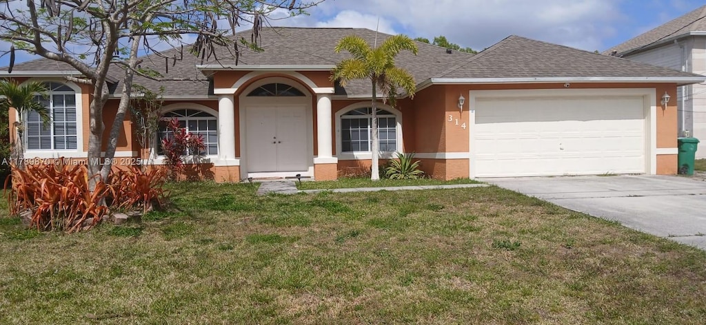 314 SW Ridgecrest Dr, Port St Lucie, FL 34953 - ranch-style home featuring a shingled roof, stucco siding, driveway, and a front yard