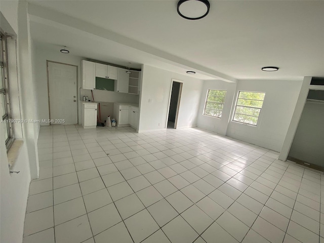 unfurnished living room featuring light tile patterned floors