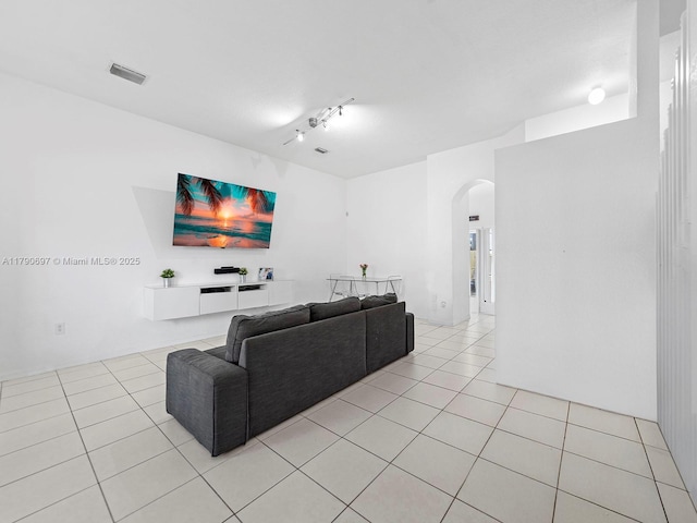 2352 SE 21st St, Homestead, FL 33035 - living room featuring track lighting, light tile patterned flooring, visible vents, and arched walkways
