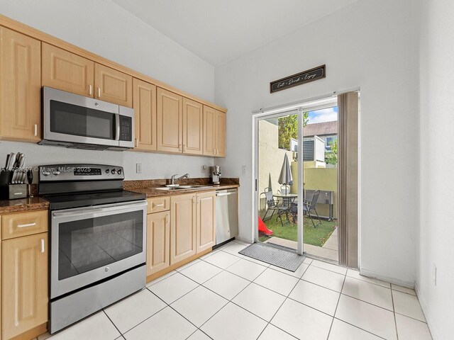 2352 SE 21st St, Homestead, FL 33035 - kitchen with light tile patterned floors, visible vents, light brown cabinets, stainless steel appliances, and arched walkways