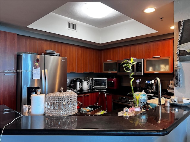 15051 Royal Oaks Ln Unit 2301, North Miami, FL 33181 - kitchen featuring stainless steel appliances, modern cabinets, dark countertops, brown cabinetry, and recessed lighting