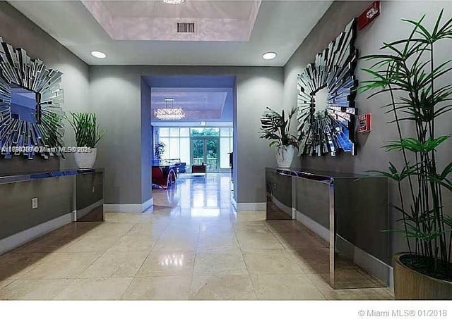 15051 Royal Oaks Ln Unit 2301, North Miami, FL 33181 - hall with baseboards, a raised ceiling, and light tile patterned floors