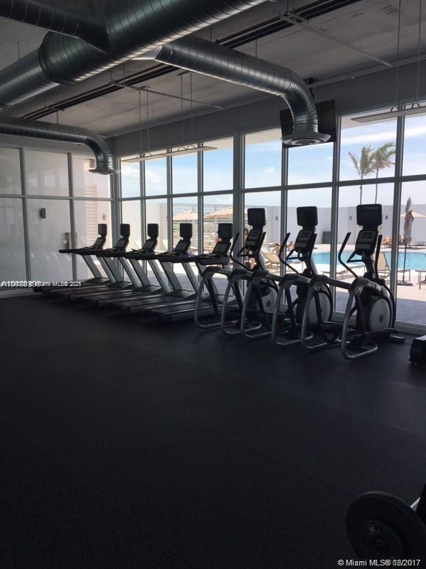 15051 Royal Oaks Ln Unit 2301, North Miami, FL 33181 - workout area with a wall of windows