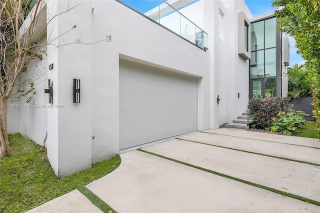 1311 Bay Dr, Miami Beach, FL 33141 - exterior space with stucco siding, concrete driveway, and an attached garage