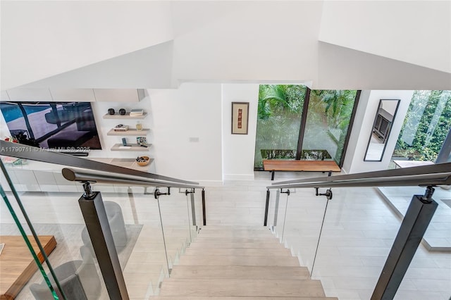 1311 Bay Dr, Miami Beach, FL 33141 - stairway featuring high vaulted ceiling, wood finished floors, and baseboards