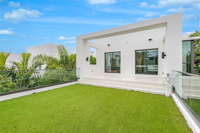 1311 Bay Dr, Miami Beach, FL 33141 - back of house with a yard and stucco siding