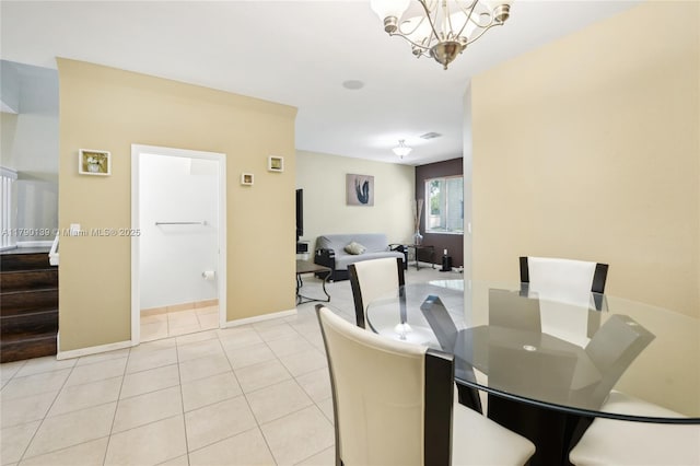 21421 NW 13th Ct Apt 211, Miami Gardens, FL 33169 - dining area featuring a chandelier, baseboards, stairs, and light tile patterned flooring